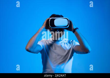 Modern architect, designer using virtual reality glasses at workplace. Designer working in augmented reality vr studio. Man working in VR goggles on a Stock Photo