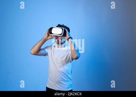 Young man designer or architect in a virtual reality headset working with a project in a virtual space. Future technology concept. Stock Photo