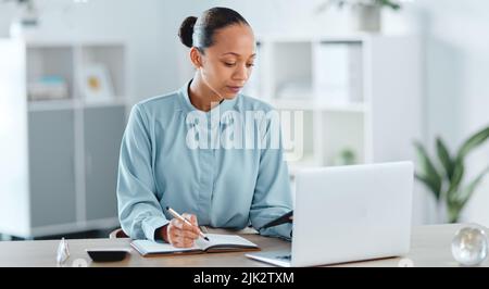 Busy, smart and serious business manager with a laptop working on schedule, planning and brainstorming ideas inside office. Lady marketing analyst Stock Photo
