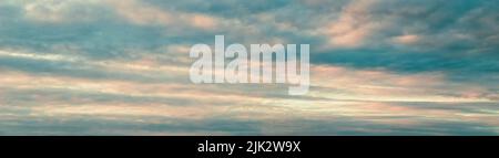 Sunset sky panorama, pink blue clouds background, cloudscape, wide large banner size Stock Photo