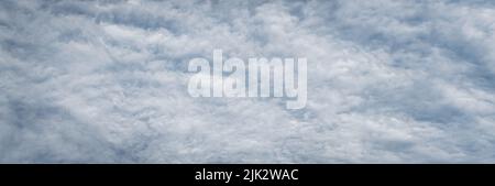 Fleecy clouds texture, cloudy sky background, wide banner size gray cloudscape Stock Photo