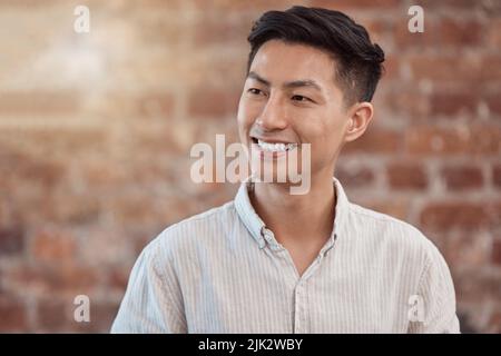 Happy, confident and smiling business man looking thoughtful while working in a creative startup agency. Cheerful, charming and positive designer Stock Photo