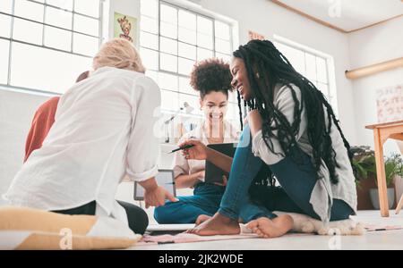 Happy, diverse and creative business people brainstorming, planning and thinking of ideas while sitting together at work. Group of smiling, cheerful Stock Photo