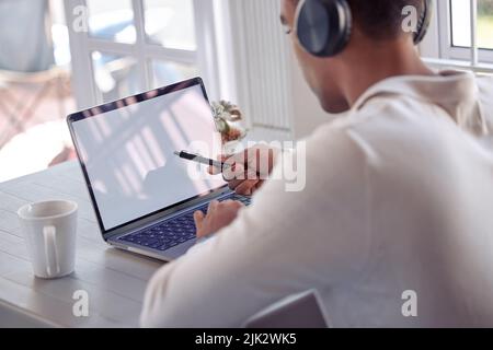 Entrepreneurship is a great leveler. a young male using his laptop at home. Stock Photo