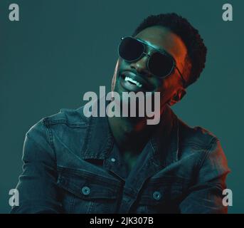I just want to spread some positivity. a man wearing sunglasses and a denim denim jacket in the studio. Stock Photo