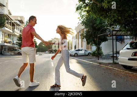 Couple has fun and laughs. Young hipster couple hugging each other in city. Summer love story, beautiful stylish young couple. Spring fashion urban concept with boyfriend and girlfriend. Select focus Stock Photo
