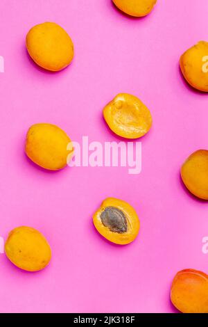 Apricot pattern. Top view of fresh fruit on a pink background. Repetition concept Stock Photo
