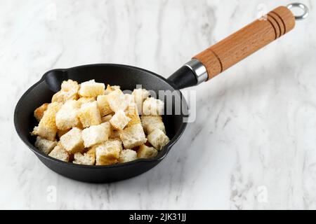 Crispy Homemade Croutons for SOup Side Dish, Served on Cast Iron Pan, Copy Space Stock Photo