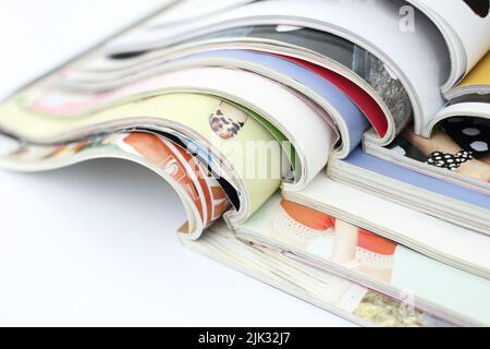 stack of magazines on white background Stock Photo