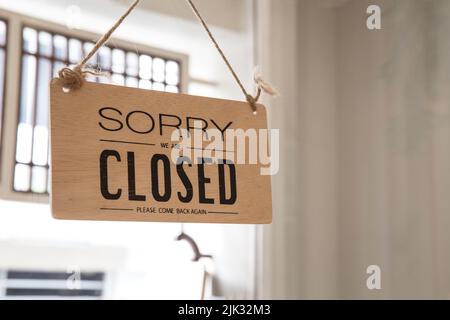 Close up of the sign board 'Closed' shop or cafe of the window at the door Stock Photo