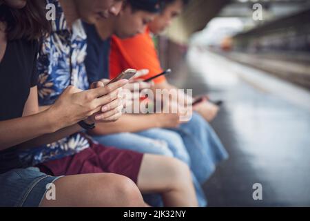 Group of friends using digital smartphones outdoor with having fun with technology trends , Teen lifestyle social media concept Stock Photo