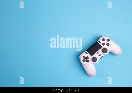 Joystick gaming controller isolated on blue background , Video game console developed Interactive Entertainment Stock Photo