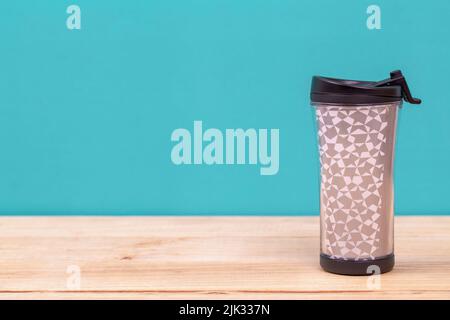 plastic tumbler glasses or thermos travel cup  isolated on wooden background Stock Photo