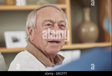 This has been an informative conversation. an elderly man having a checkup with an unrecognizable nurse at home. Stock Photo