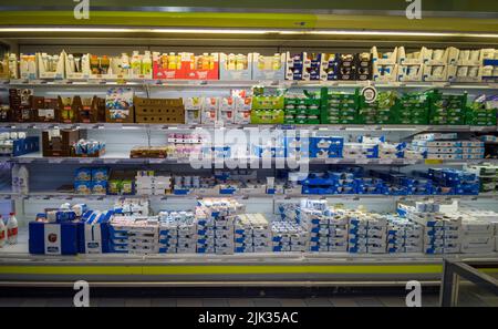 Fossano, Italy - July 29, 2022: Refrigerator shelf with Yogurt packages in Italian supermarket Eurospin. Stock Photo