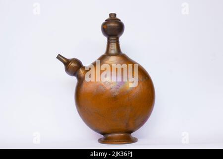 kendi or jug isolated on white background. kendi is traditional jug from indonesia. kendi made from earthenware or clay Stock Photo