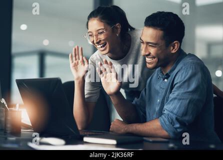 Started as a scary idea. two young workers using a laptop for a business meeting in a modern office. Stock Photo