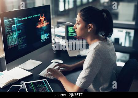 No one blocking this shine. a young woman using a computer in a modern office. Stock Photo