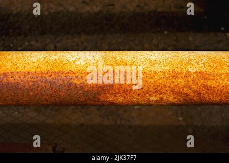 Gas Rusty steel pipe, Steel pipes are placed in the factory, steel pipe for manufacturing. Old yellow pipe on a dark background Stock Photo