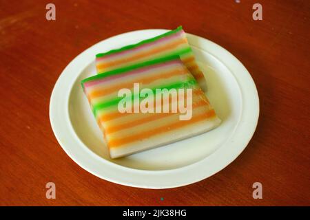 lapis cake or roti lapis or layer cake or lapis legit served in little plate isolated on white background made from rice flour, starch, coconut milk, Stock Photo