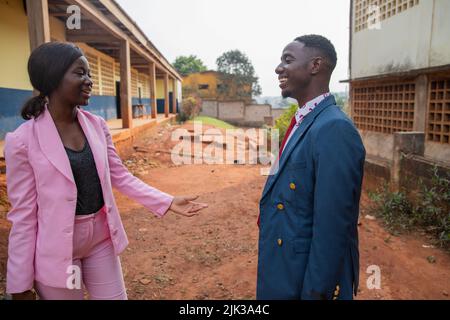 A girl and a boy, friends are having a heated discussion in a schoolyard in Africa. Stock Photo