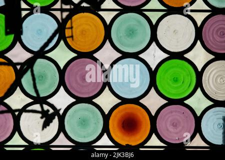 coloured circular glasses at a windows in Can Ferrat Museum, Sitges, Spain Stock Photo