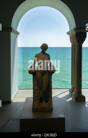 Hall with statues and a large window to the sea in the Marisel Museum, Sitges, Spain Stock Photo