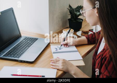 Worker or student woman writing Think big motivational phrase in open notebook Stock Photo