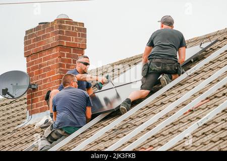Electrician installing solar panels Stock Photo