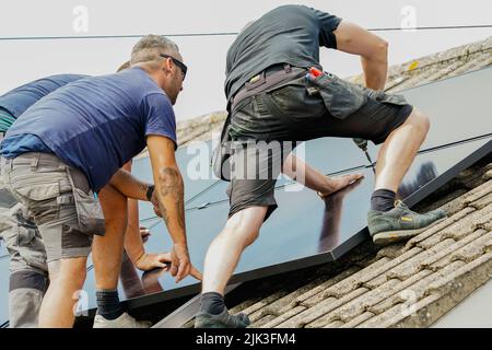 Electrician installing solar panels Stock Photo