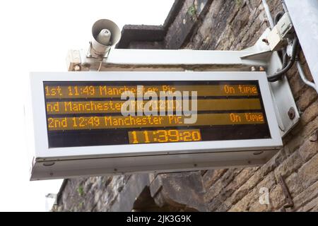 Mossley, UK. 30th July, 2022. 30.7.2022 Mossley UK Commuters boarding the Mossley to Manchester Piccadilly train under normal service. Credit: Peter Liggins/Alamy Live News Stock Photo