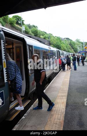 Mossley, UK. 30th July, 2022. 30.7.2022 Mossley UK Commuters boarding the Mossley to Manchester Piccadilly train under normal service. Credit: Peter Liggins/Alamy Live News Stock Photo