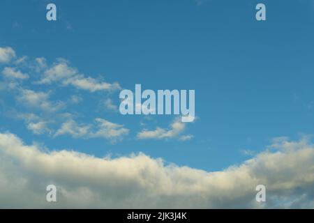 Dark blue evening sky with clouds. Blue hour. Heavenly natural background to overlay on your photos. Stock Photo