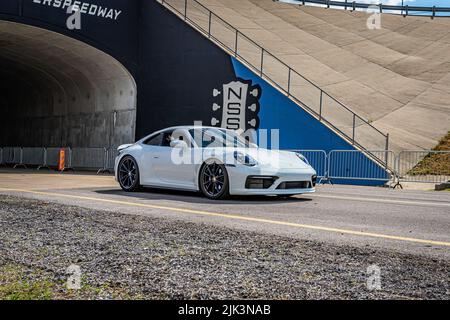 Lebanon, TN - May 14, 2022: Wide angle front corner view of a 2020 Porsche 911 Carrera S Coupe leaving a local car show. Stock Photo