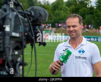 Illertissen, Germany. 30th July, 2022. Soccer: DFB Cup, FV Illertissen - 1. FC Heidenheim, 1st round, Vöhlin Stadium. Illertissen coach Marco Konrad gives a TV interview. Credit: Stefan Puchner/dpa - IMPORTANT NOTE: In accordance with the requirements of the DFL Deutsche Fußball Liga and the DFB Deutscher Fußball-Bund, it is prohibited to use or have used photographs taken in the stadium and/or of the match in the form of sequence pictures and/or video-like photo series./dpa/Alamy Live News Stock Photo