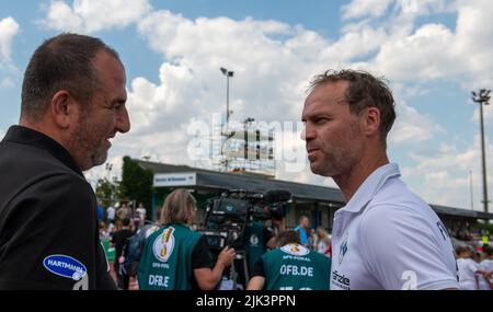 Illertissen, Germany. 30th July, 2022. Soccer: DFB Cup, FV Illertissen - 1. FC Heidenheim, 1st round, Vöhlin Stadium. Illertissen coach Marco Konrad (r9) talks to Heidenheim coach Frank Schmidt. Credit: Stefan Puchner/dpa - IMPORTANT NOTE: In accordance with the requirements of the DFL Deutsche Fußball Liga and the DFB Deutscher Fußball-Bund, it is prohibited to use or have used photographs taken in the stadium and/or of the match in the form of sequence pictures and/or video-like photo series./dpa/Alamy Live News Stock Photo