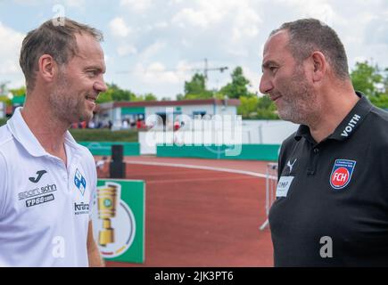 Illertissen, Germany. 30th July, 2022. Soccer: DFB Cup, FV Illertissen - 1. FC Heidenheim, 1st round, Vöhlin Stadium. Illertissen coach Marco Konrad (l) talks to Heidenheim coach Frank Schmidt. Credit: Stefan Puchner/dpa - IMPORTANT NOTE: In accordance with the requirements of the DFL Deutsche Fußball Liga and the DFB Deutscher Fußball-Bund, it is prohibited to use or have used photographs taken in the stadium and/or of the match in the form of sequence pictures and/or video-like photo series./dpa/Alamy Live News Stock Photo