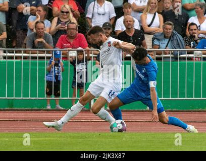 Illertissen, Germany. 30th July, 2022. Soccer: DFB-Pokal, FV Illertissen - 1. FC Heidenheim, 1st round, Vöhlin-Stadion. Illertissen's Fabio Maiolo (r) and Heidenheim's Denis Thomalla fight for the ball. Credit: Stefan Puchner/dpa - IMPORTANT NOTE: In accordance with the requirements of the DFL Deutsche Fußball Liga and the DFB Deutscher Fußball-Bund, it is prohibited to use or have used photographs taken in the stadium and/or of the match in the form of sequence pictures and/or video-like photo series./dpa/Alamy Live News Stock Photo