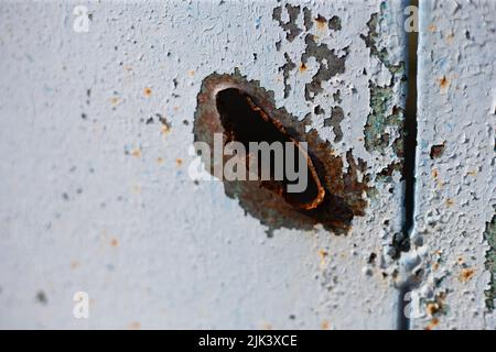 Fence near the house with bullet holes and charapnels after gunshots and fighting during the invasion of Russian troops into Ukraine Stock Photo