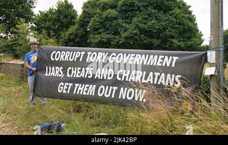 Protester Steve Bray demonstrates near Daylesford House in Gloucestershire, where Prime Minister Boris Johnson and wife Carrie are holding a first wedding anniversary party for friends and family. Picture date: Saturday July 30, 2022. Stock Photo