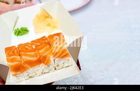 Fresh delicious sushi set with red fish, ginger, fast delivered to home office Stock Photo