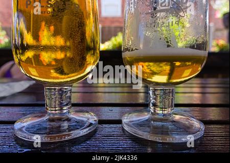 https://l450v.alamy.com/450v/2jk4336/two-glasses-of-beer-on-a-tabletop-with-one-partly-drunk-2jk4336.jpg