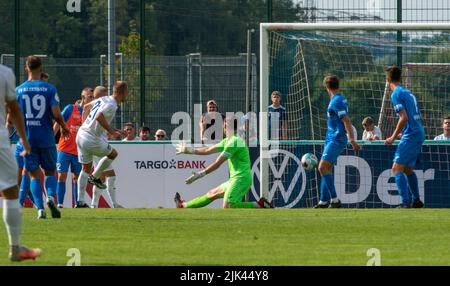 Illertissen, Germany. 30th July, 2022. Soccer: DFB Cup, FV Illertissen - 1. FC Heidenheim, 1st round, Vöhlin Stadium. Heidenheim's Adrian Beck (2nd from left) scores the 0:2. Credit: Stefan Puchner/dpa - IMPORTANT NOTE: In accordance with the requirements of the DFL Deutsche Fußball Liga and the DFB Deutscher Fußball-Bund, it is prohibited to use or have used photographs taken in the stadium and/or of the match in the form of sequence pictures and/or video-like photo series./dpa/Alamy Live News Stock Photo