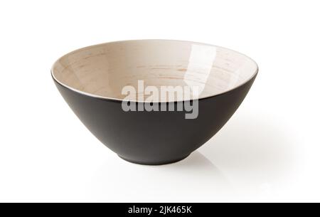 Porcelain bowl isolated on a white background. Black ramekin decorated inside with brown circular lines over beige background. Modern tableware cutout Stock Photo
