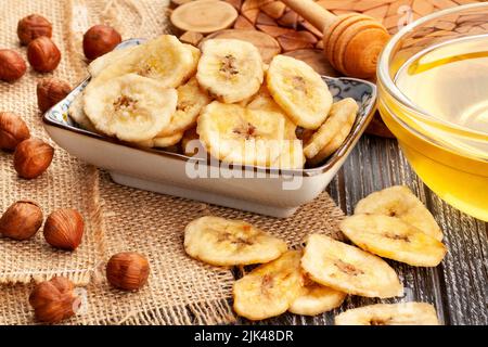 banana chips on wood background Stock Photo