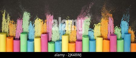 Multicolored chalk on black board. Back to school. Colored background. Banner Stock Photo