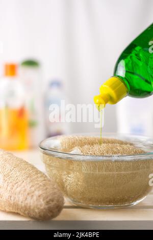 cleaning gourd luffa or loofah fruit or sponge gourd in a solution of water and detergent to get rid of fungal and bacteria before use, soft-focus Stock Photo