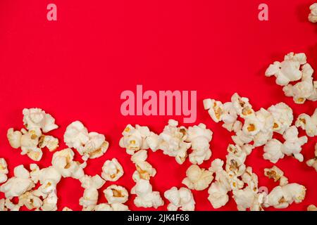 Popcorn on red background, top view with space for text Stock Photo