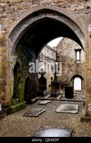 Arches and Irish High Crosses at Burrishoole Friary ruins in County Mayo, Ireland. Stock Photo