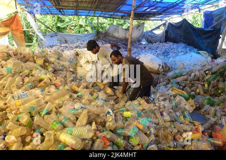 Workers seen sorting plastic bottles at a workshop before sending them for recycling. Plastic bottles are recycled and turned into polyester which is used in garments and jerseys all over the world. Many countries have started to ban single use plastics to tackle the environmental issues. Stock Photo